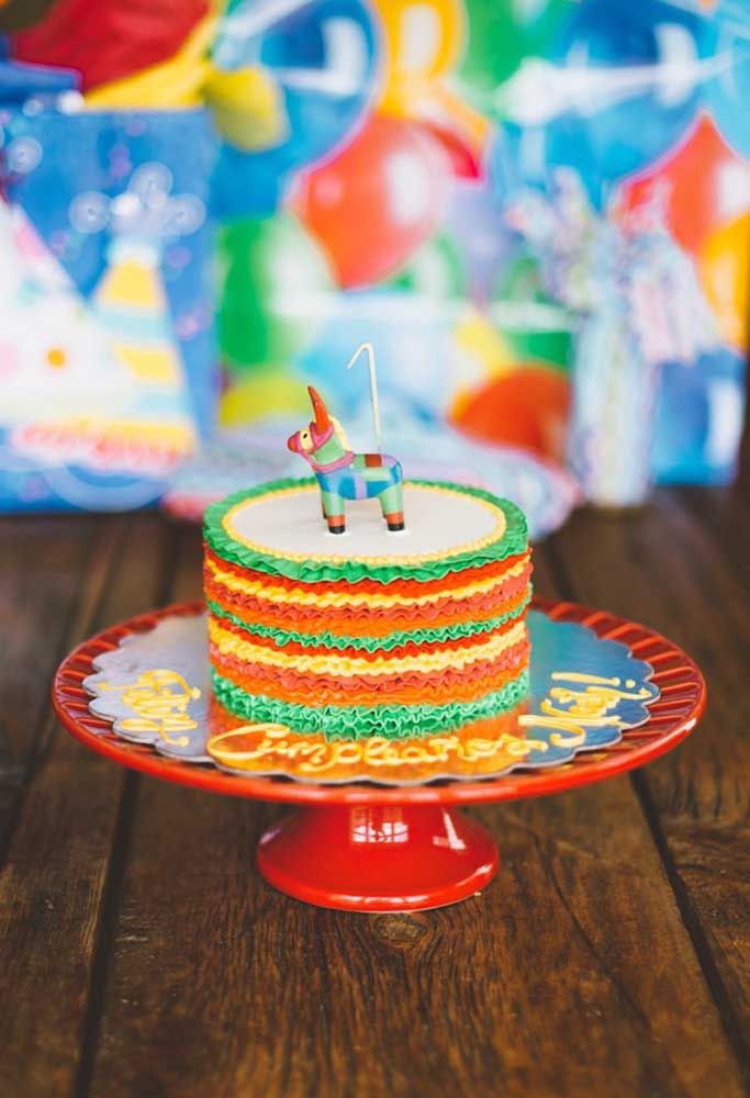 Des couches colorées de crème fouettée et une mini pinata décorent ce petit gâteau de fête mexicain