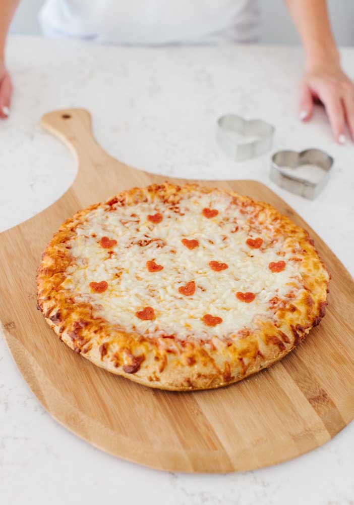 De délicats petits coeurs décorent cette pizza à la mozzarella 