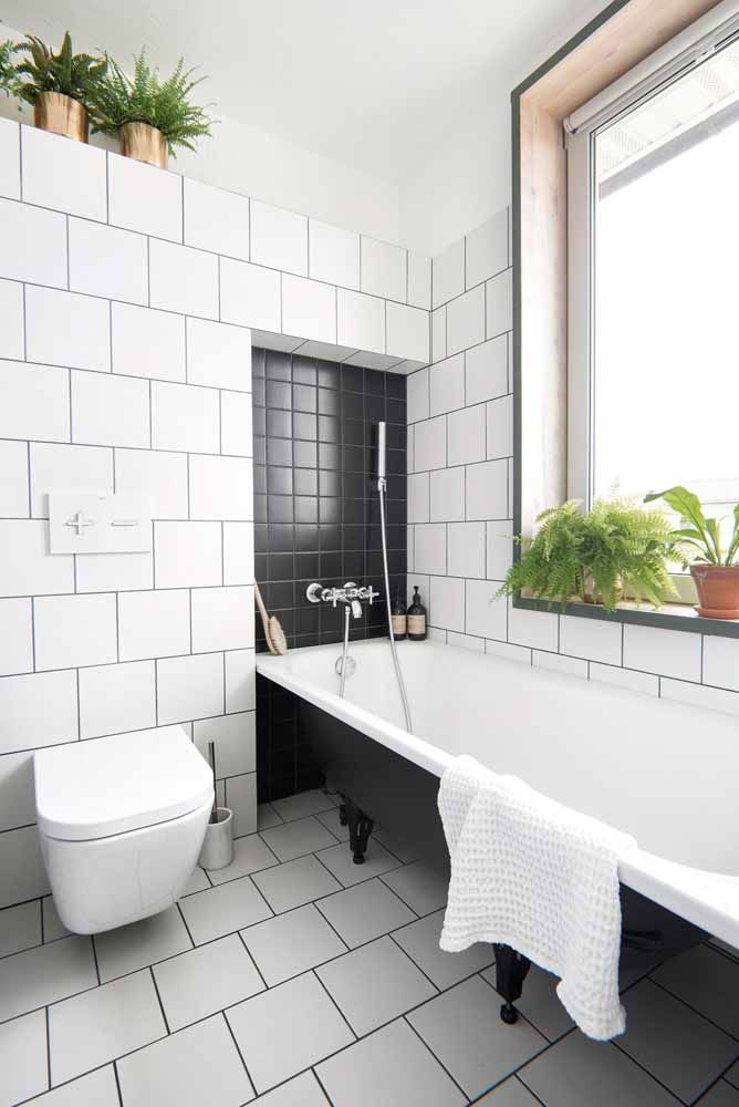 Le vert des plantes apporte chaleur et confort à la salle de bain en noir et blanc